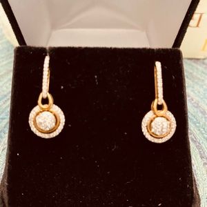 Dangling diamond earrings.